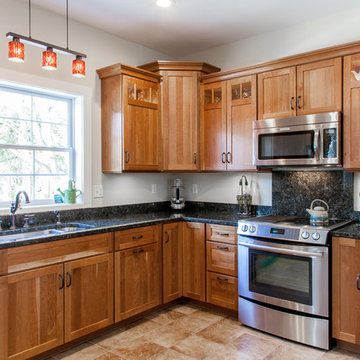 Natural Cherry Shaker kitchen with dark granite countertops