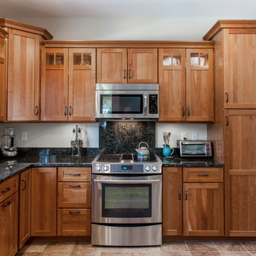 Natural Cherry Shaker kitchen with dark granite countertops