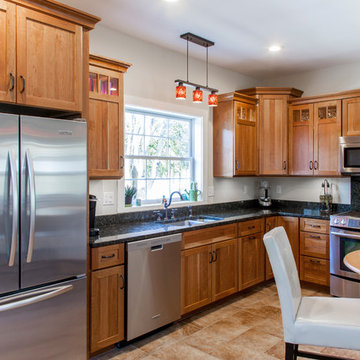 Natural Cherry Shaker kitchen with dark granite countertops
