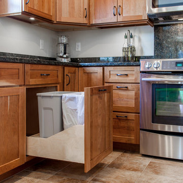 Natural Cherry Shaker kitchen with dark granite countertops