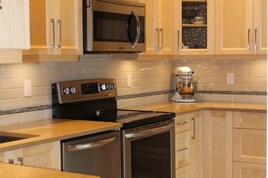 Example of a classic kitchen design in Vancouver with light wood cabinets, quartz countertops, white backsplash and ceramic backsplash