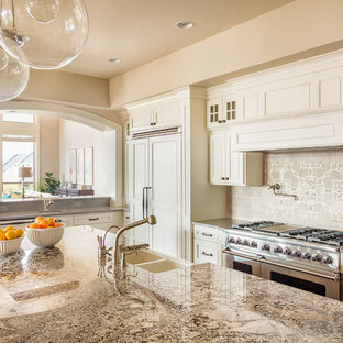Large transitional l-shaped separate kitchen in Houston with a farmhouse sink, beaded inset cabinets, beige cabinets, granite benchtops, grey splashback, panelled appliances, with island, brown benchtop and ceramic splashback.