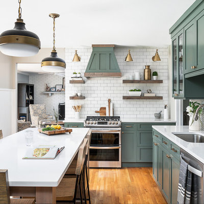 Mid-sized country l-shaped medium tone wood floor and brown floor kitchen photo in Chicago with an undermount sink, shaker cabinets, green cabinets, quartz countertops, white backsplash, cement tile backsplash, stainless steel appliances, an island and white countertops