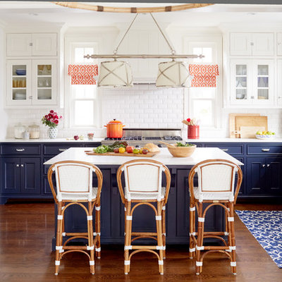 Inspiration for a large coastal dark wood floor eat-in kitchen remodel in Los Angeles with a farmhouse sink, beaded inset cabinets, blue cabinets, marble countertops, white backsplash, stainless steel appliances, an island and subway tile backsplash