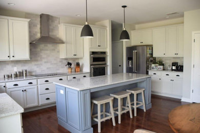 Eat-in kitchen - large transitional u-shaped brown floor eat-in kitchen idea in Philadelphia with quartzite countertops, gray backsplash, stainless steel appliances and an island