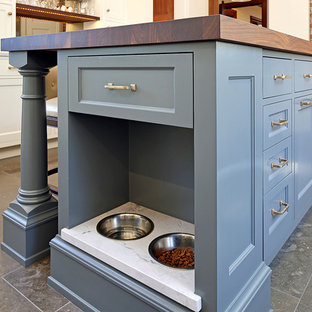 Inspiration for a transitional kitchen in Seattle with recessed-panel cabinets, blue cabinets, wood benchtops, ceramic floors, with island, black floor and brown benchtop.