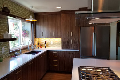 Inspiration for a large 1960s u-shaped medium tone wood floor kitchen remodel in Boise with a double-bowl sink, flat-panel cabinets, dark wood cabinets, quartz countertops, ceramic backsplash, stainless steel appliances, an island and white countertops