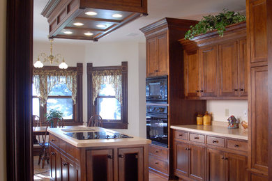 Example of a classic galley enclosed kitchen design in Other with beaded inset cabinets, dark wood cabinets, laminate countertops and black appliances