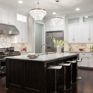 Example of a transitional l-shaped kitchen design in Charleston with an undermount sink, shaker cabinets, white cabinets, multicolored backsplash, matchstick tile backsplash and stainless steel appliances