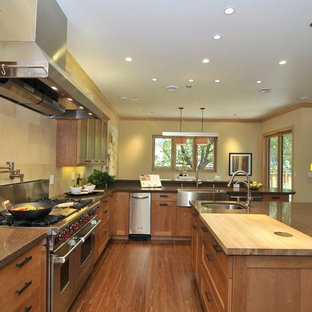 Large transitional open concept kitchen remodeling - Open concept kitchen - large transitional u-shaped medium tone wood floor open concept kitchen idea in San Francisco with a farmhouse sink, shaker cabinets, medium tone wood cabinets, quartz countertops, beige backsplash, stone tile backsplash and stainless steel appliances