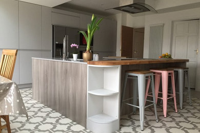 Inspiration for a large modern u-shaped open plan kitchen in Sussex with flat-panel cabinets, grey cabinets, quartz worktops and an island.