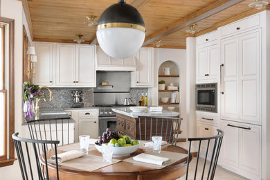 Eat-in kitchen - large traditional l-shaped eat-in kitchen idea in St Louis with flat-panel cabinets, white cabinets, quartz countertops, blue backsplash, marble backsplash, paneled appliances, an island and gray countertops