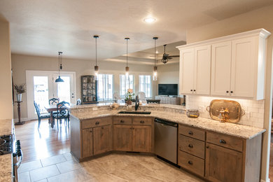 Eat-in kitchen - mid-sized shabby-chic style l-shaped ceramic tile and beige floor eat-in kitchen idea in Other with an undermount sink, recessed-panel cabinets, white cabinets, granite countertops, white backsplash, subway tile backsplash and stainless steel appliances