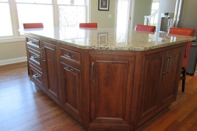 Inspiration for a timeless l-shaped medium tone wood floor eat-in kitchen remodel in Indianapolis with an undermount sink, recessed-panel cabinets, medium tone wood cabinets, granite countertops, an island and stainless steel appliances