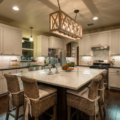 Elegant l-shaped kitchen photo in Austin with a farmhouse sink, marble countertops and white cabinets