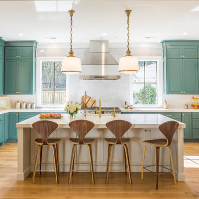 Inspiration for a large transitional u-shaped light wood floor open concept kitchen remodel in Other with shaker cabinets, green cabinets, quartz countertops, white backsplash, stainless steel appliances and an island