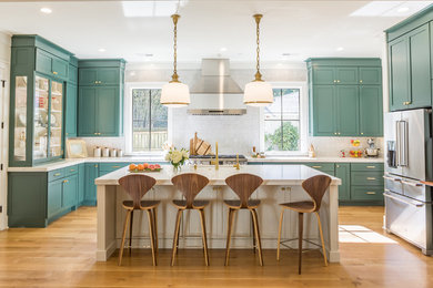 Inspiration for a large transitional u-shaped light wood floor open concept kitchen remodel in Other with shaker cabinets, green cabinets, quartz countertops, white backsplash, stainless steel appliances and an island