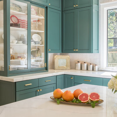 Example of a large transitional u-shaped light wood floor open concept kitchen design in Other with shaker cabinets, green cabinets, quartz countertops, white backsplash, stainless steel appliances and an island