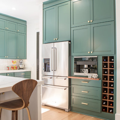 Open concept kitchen - large transitional u-shaped light wood floor open concept kitchen idea in Other with shaker cabinets, green cabinets, quartz countertops, white backsplash, stainless steel appliances and an island