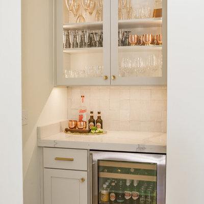 Example of a large transitional u-shaped light wood floor open concept kitchen design in Other with shaker cabinets, gray cabinets, quartz countertops, white backsplash, stainless steel appliances and an island