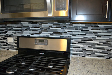 Example of a classic kitchen design in Chicago with glass tile backsplash
