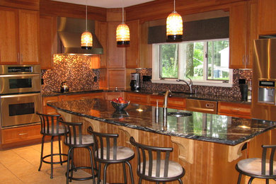 Example of a large arts and crafts l-shaped ceramic tile eat-in kitchen design in Bridgeport with an undermount sink, shaker cabinets, medium tone wood cabinets, granite countertops, multicolored backsplash, mosaic tile backsplash, stainless steel appliances and an island