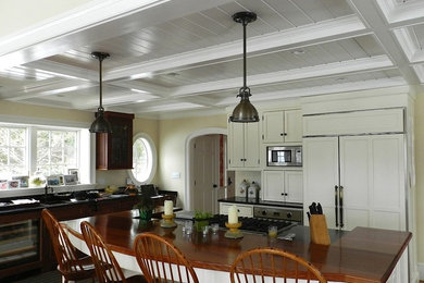 Example of a large classic u-shaped medium tone wood floor and brown floor eat-in kitchen design in DC Metro with a drop-in sink, shaker cabinets, white cabinets, paneled appliances, an island, wood countertops and brown backsplash