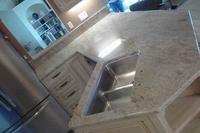 Example of a trendy porcelain tile kitchen design in Miami with an undermount sink, granite countertops and stainless steel appliances