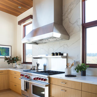 Design ideas for an expansive modern l-shaped open plan kitchen in San Francisco with an undermount sink, flat-panel cabinets, light wood cabinets, marble benchtops, white splashback, marble splashback, stainless steel appliances, marble floors, with island, white floor and white benchtop.