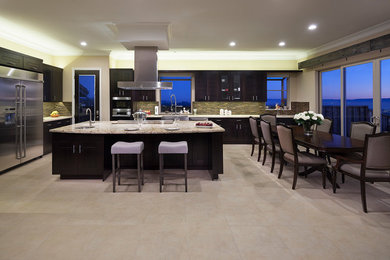 Example of a mid-sized trendy l-shaped porcelain tile and beige floor eat-in kitchen design in San Francisco with an undermount sink, glass-front cabinets, dark wood cabinets, granite countertops, beige backsplash, matchstick tile backsplash, stainless steel appliances and an island