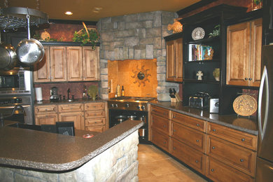 Eat-in kitchen - traditional l-shaped eat-in kitchen idea in Other with a farmhouse sink, raised-panel cabinets, light wood cabinets, solid surface countertops, multicolored backsplash, metal backsplash and stainless steel appliances