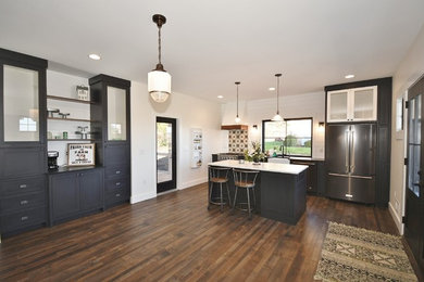 Inspiration for a large transitional u-shaped dark wood floor and brown floor eat-in kitchen remodel in Other with a farmhouse sink, recessed-panel cabinets, black cabinets, quartz countertops, multicolored backsplash, ceramic backsplash, stainless steel appliances, an island and white countertops