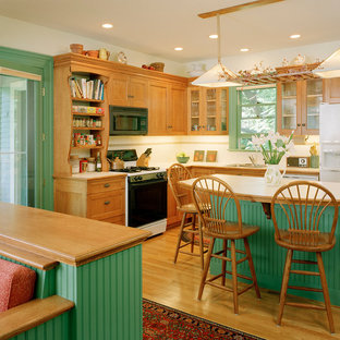 Design ideas for a victorian kitchen in Boston with white appliances and green cabinets.