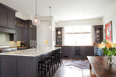 Eat-in kitchen - large transitional galley dark wood floor and brown floor eat-in kitchen idea in Toronto with shaker cabinets, dark wood cabinets, multicolored backsplash, matchstick tile backsplash, stainless steel appliances, an island, an undermount sink and granite countertops