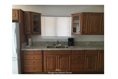 Example of a mid-sized classic l-shaped medium tone wood floor and brown floor kitchen design in Las Vegas with an undermount sink, raised-panel cabinets, granite countertops and no island