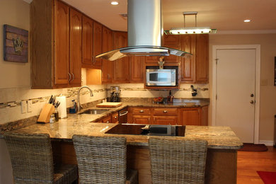 Kitchen - traditional u-shaped kitchen idea in New Orleans with granite countertops, multicolored backsplash and an island