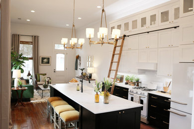 Open concept kitchen - small transitional single-wall medium tone wood floor open concept kitchen idea in New Orleans with a farmhouse sink, shaker cabinets, white cabinets, marble countertops, white backsplash, ceramic backsplash, white appliances and an island