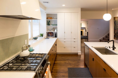 Mid-sized minimalist l-shaped dark wood floor and brown floor open concept kitchen photo in Philadelphia with an undermount sink, flat-panel cabinets, medium tone wood cabinets, quartz countertops, green backsplash, matchstick tile backsplash, stainless steel appliances and an island