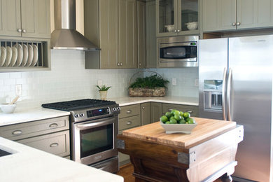 Mid-sized country u-shaped medium tone wood floor and brown floor kitchen photo in Other with an undermount sink, blue backsplash, subway tile backsplash, stainless steel appliances, shaker cabinets, green cabinets, marble countertops and an island