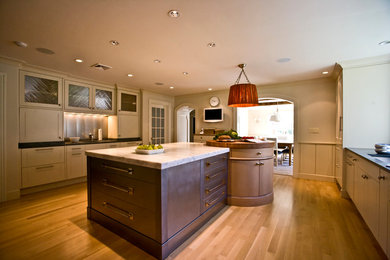 Photo of a modern kitchen/diner in New York with marble worktops and an island.