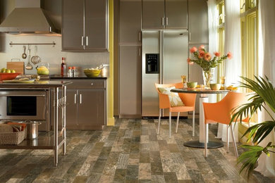 Mid-sized trendy single-wall vinyl floor eat-in kitchen photo in Seattle with flat-panel cabinets, mirror backsplash, stainless steel cabinets, metallic backsplash, stainless steel appliances and no island