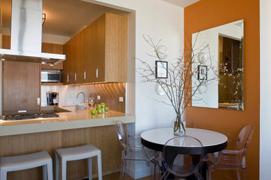 Example of a mid-sized eclectic l-shaped medium tone wood floor eat-in kitchen design in New York with an undermount sink, flat-panel cabinets, light wood cabinets, limestone countertops, stone slab backsplash, stainless steel appliances and an island