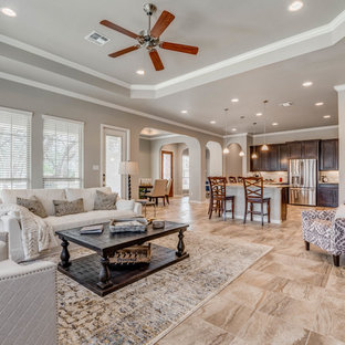 Inspiration for a mid-sized arts and crafts single-wall open plan kitchen in Austin with recessed-panel cabinets, dark wood cabinets, granite benchtops, beige splashback, stone tile splashback, stainless steel appliances, ceramic floors, with island, multi-coloured floor and multi-coloured benchtop.