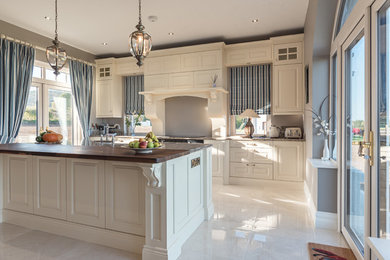 Inspiration for a large classic kitchen in Other with a belfast sink, raised-panel cabinets, beige cabinets, quartz worktops, an island and brown worktops.