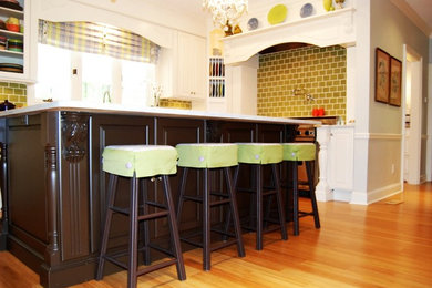 Large elegant u-shaped bamboo floor eat-in kitchen photo in Atlanta with raised-panel cabinets, white cabinets, quartzite countertops, green backsplash, subway tile backsplash, stainless steel appliances, an island and a double-bowl sink
