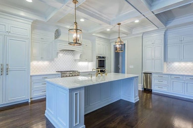 Eat-in kitchen - large contemporary l-shaped dark wood floor and brown floor eat-in kitchen idea in Orange County with a farmhouse sink, raised-panel cabinets, white cabinets, marble countertops, white backsplash, mosaic tile backsplash, stainless steel appliances and an island