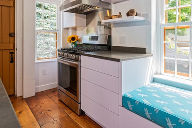 Eat-in kitchen - small transitional u-shaped dark wood floor and brown floor eat-in kitchen idea in Providence with an undermount sink, flat-panel cabinets, white cabinets, quartz countertops, stainless steel appliances, an island and gray countertops