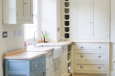Photo of a medium sized classic kitchen/diner in Devon with shaker cabinets and wood worktops.
