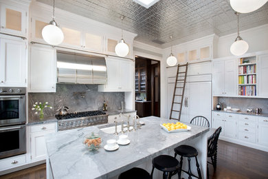 This is an example of a medium sized classic u-shaped enclosed kitchen in Boston with a submerged sink, recessed-panel cabinets, white cabinets, marble worktops, blue splashback, marble splashback, stainless steel appliances, dark hardwood flooring, an island and brown floors.