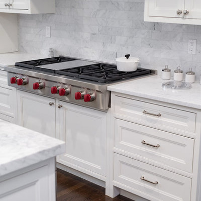 Eat-in kitchen - huge traditional l-shaped dark wood floor and brown floor eat-in kitchen idea in Boston with an undermount sink, beaded inset cabinets, white cabinets, marble countertops, gray backsplash, marble backsplash, stainless steel appliances, an island and white countertops